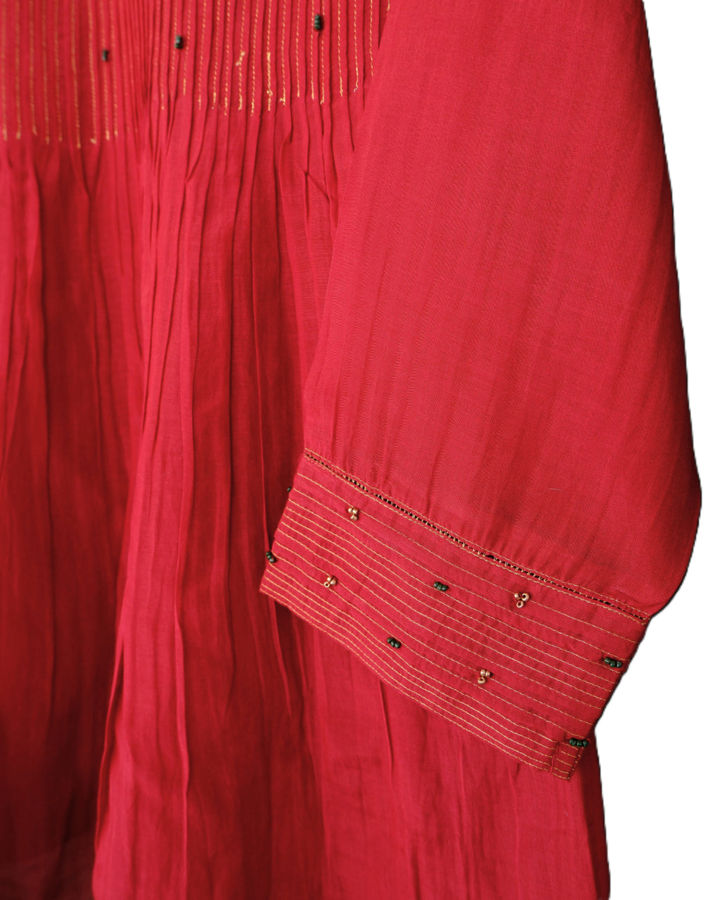 Red garment with intricate detailing on a white background